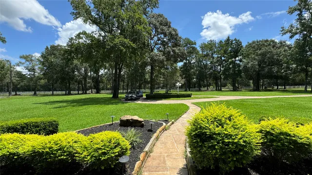a swimming pool with chairs and table and chairs