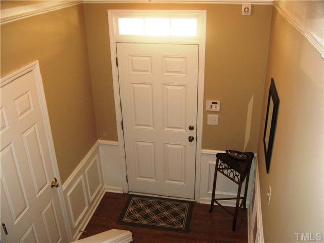 4928 Wyatt Brook Way Raleigh, NC 27609 - Photo 3 of 14 Welcome guests into your beautiful home through this foyer donned with rich hardwoods and wainscot mouldings. As you tour the home, you will see other embellishments such as plantation blinds, current lightling choices, and new paint.