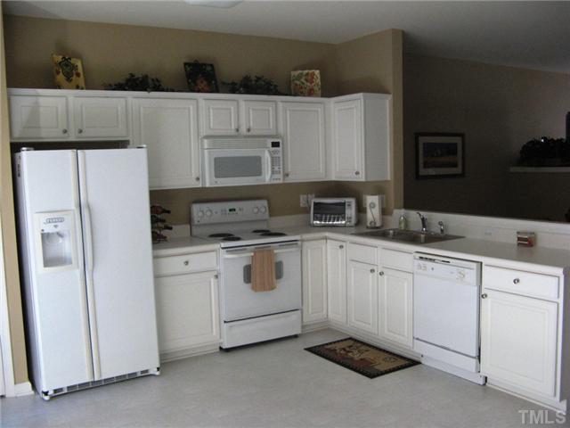 4928 Wyatt Brook Way Raleigh, NC 27609 - Photo 6 of 14 To the left of the dining area is your Cook's kitchen. A plethora of cabinetry & countertop space as well as the built-in microwave, make this a fully functional area. The fridge is negotiable if you would like to move right in with matching appliances.