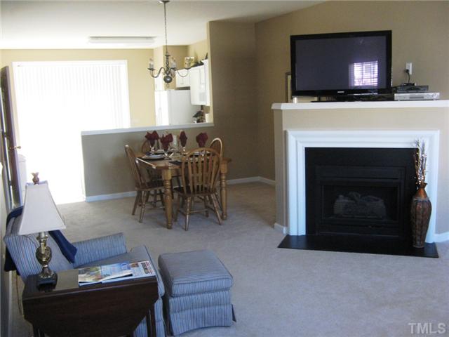 4928 Wyatt Brook Way Raleigh, NC 27609 - Photo 14 of 14 As you can see, your transitional floor plan has a great open feel, especially with the angled fireplace. At the far end of the kitchen, the sliding glass doors take you to your private deck.