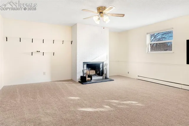a view of an empty room with a fireplace