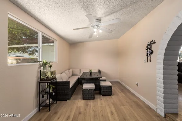 a living room with furniture and a wooden floor