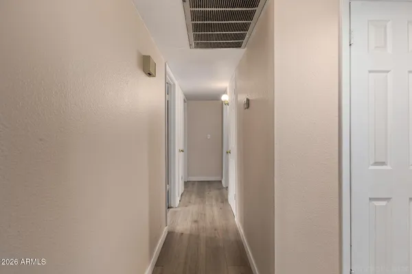a view of hallway with wooden floor