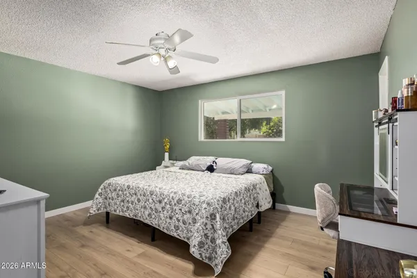 a bedroom with a bed and a flat screen tv