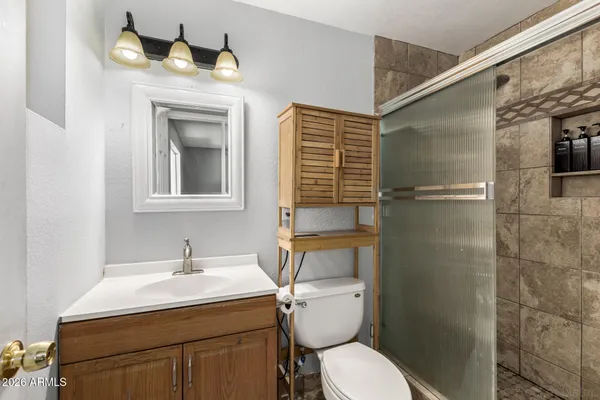 a bathroom with a sink toilet and shower