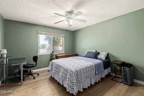 a bedroom with bed chair and window