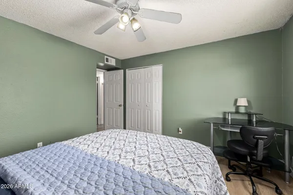 a bedroom with a bed and a desk