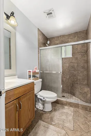 a bathroom with a toilet sink and shower