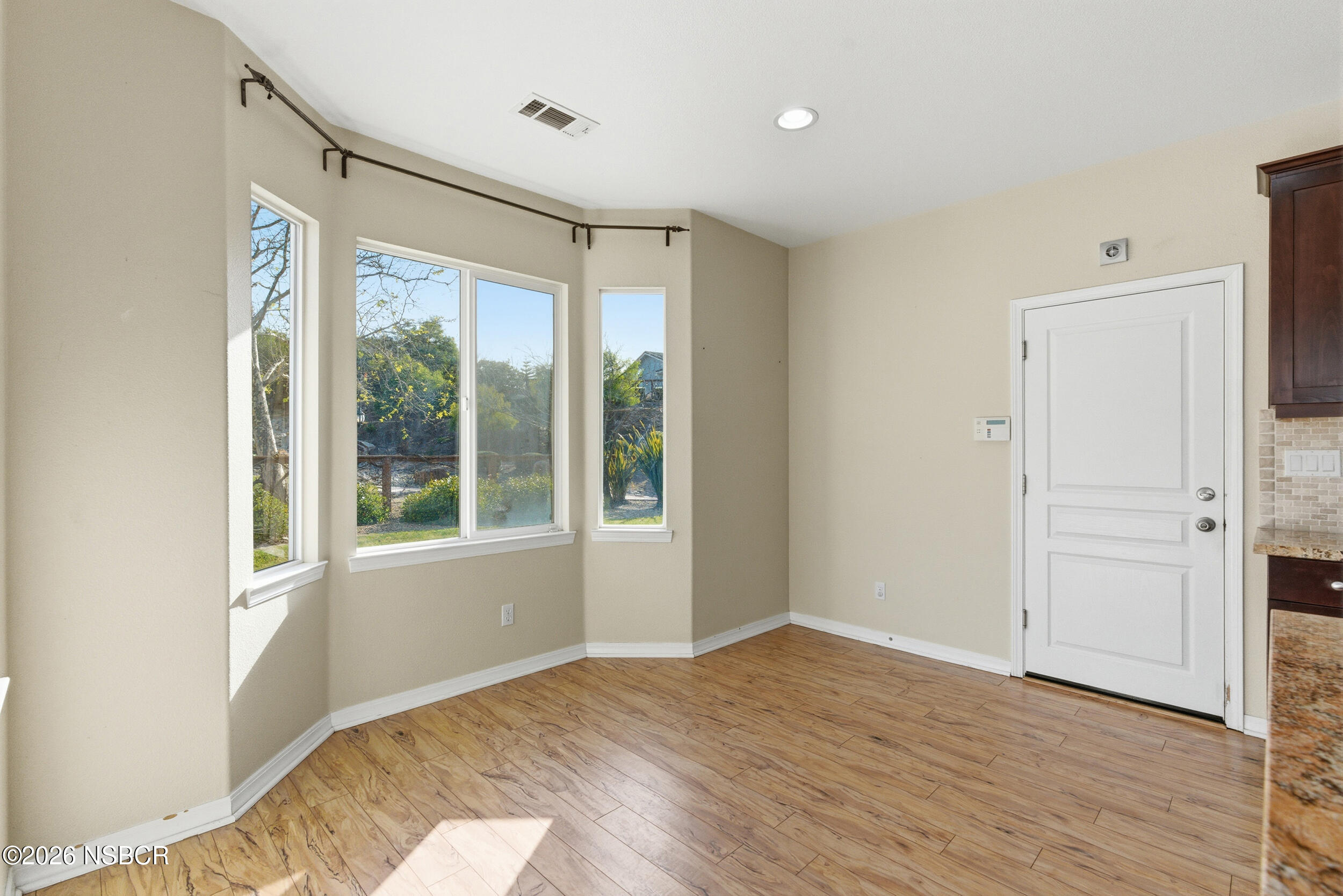 5632 Menemsha Lane Santa Maria, CA 93455 - Photo 12 of 65 a view of an empty room with wooden floor and a window