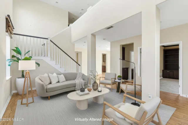 a view of a workspace with furniture and a potted plant