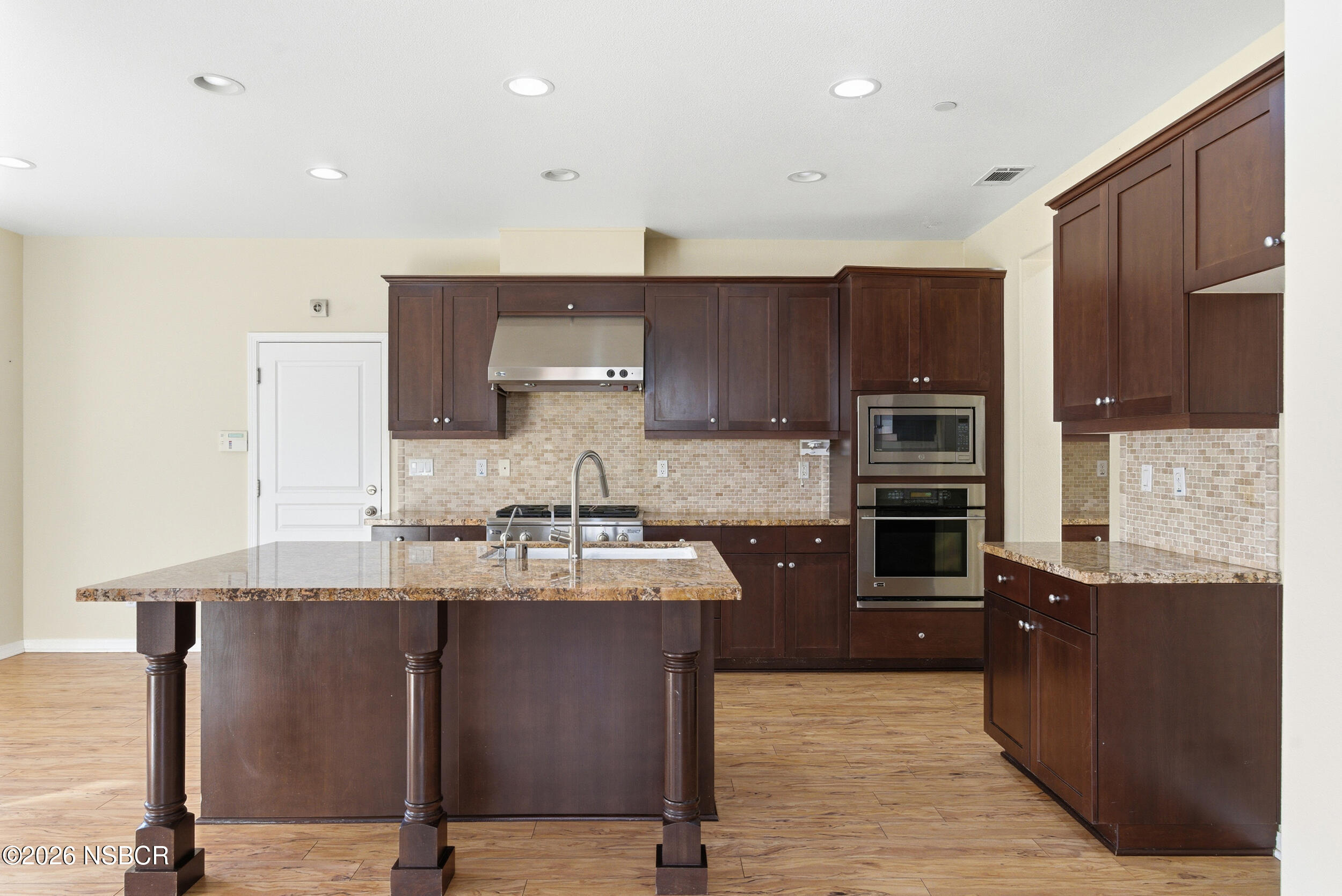 5632 Menemsha Lane Santa Maria, CA 93455 - Photo 8 of 65 a large kitchen with stainless steel appliances granite countertop a stove a sink and a microwave
