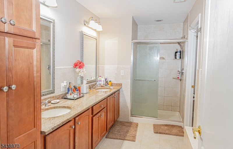 419 Putnam Road Union, NJ 07083 - Photo 18 of 37 a bathroom with a granite countertop shower sink and mirror