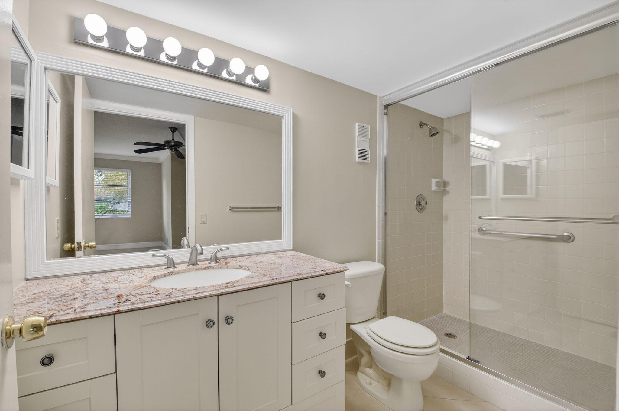 6935 Huntington Lane, Unit 207 Delray Beach, FL 33446 - Photo 32 of 88 a bathroom with a sink a toilet and shower