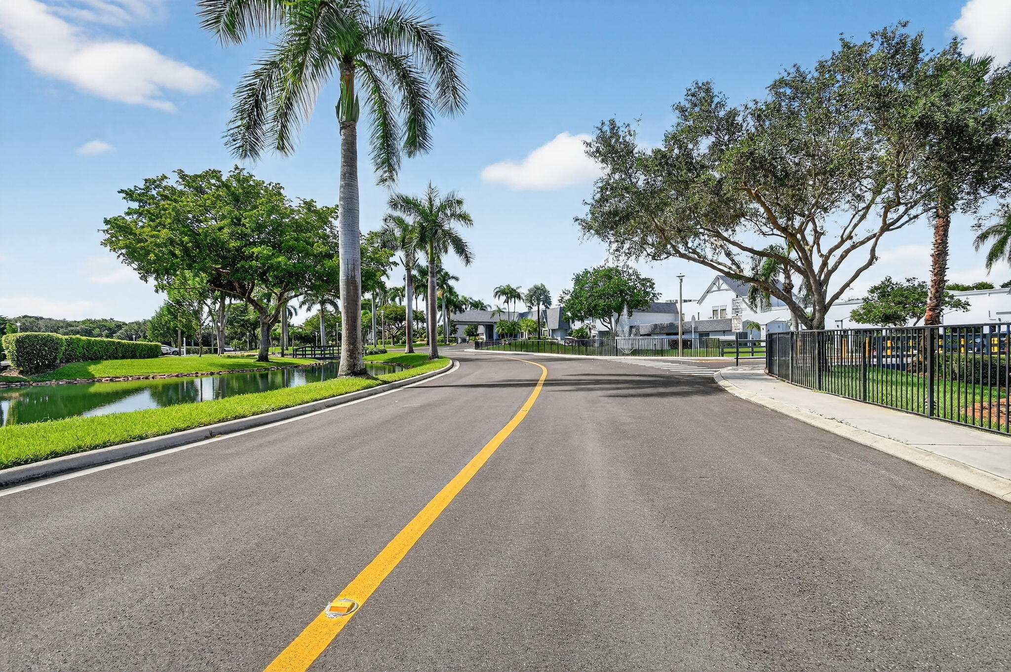 6935 Huntington Lane, Unit 207 Delray Beach, FL 33446 - Photo 37 of 88 a view of swimming pool with a yard and palm trees