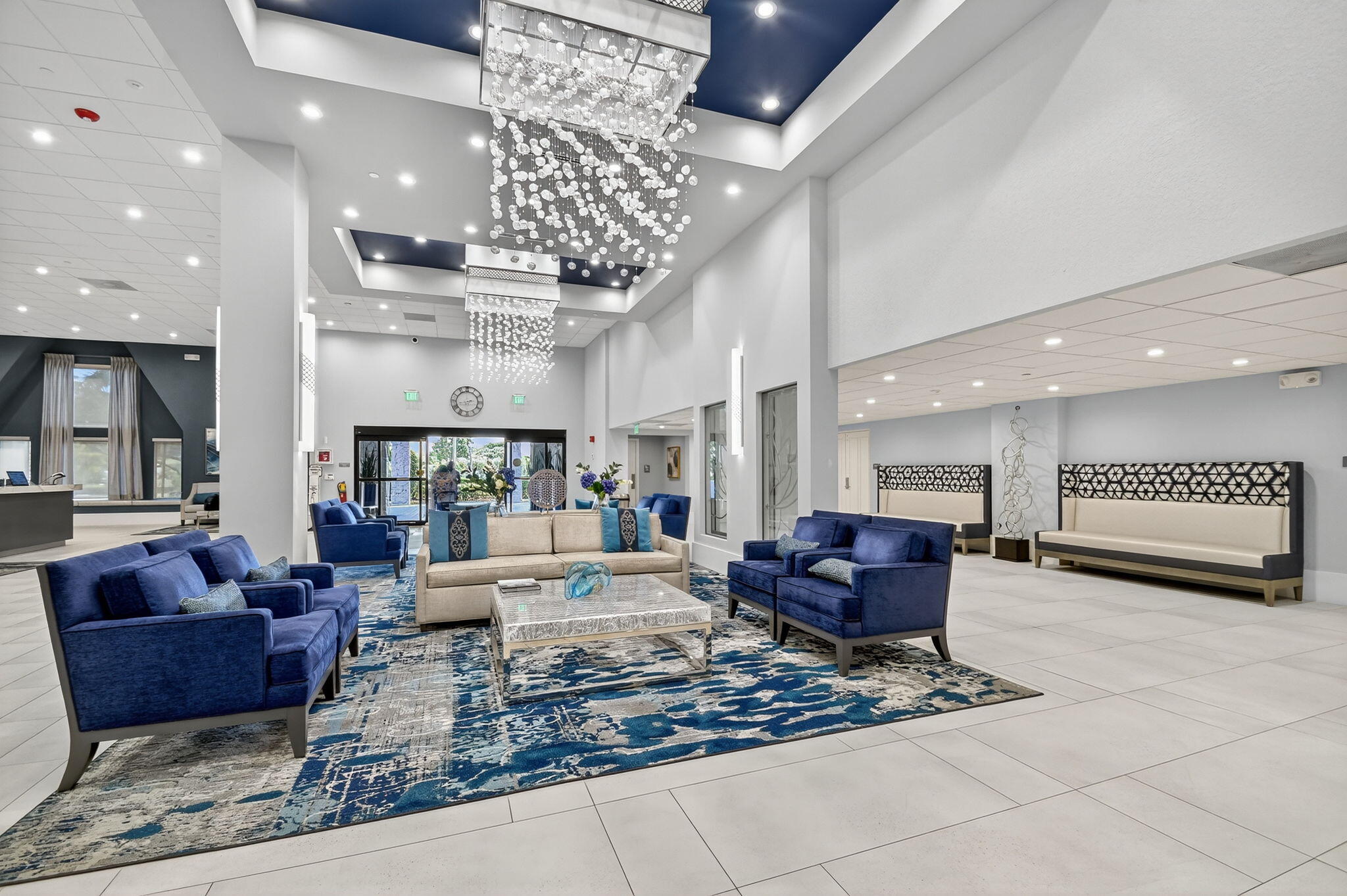 6935 Huntington Lane, Unit 207 Delray Beach, FL 33446 - Photo 41 of 88 a living room with furniture and a chandelier