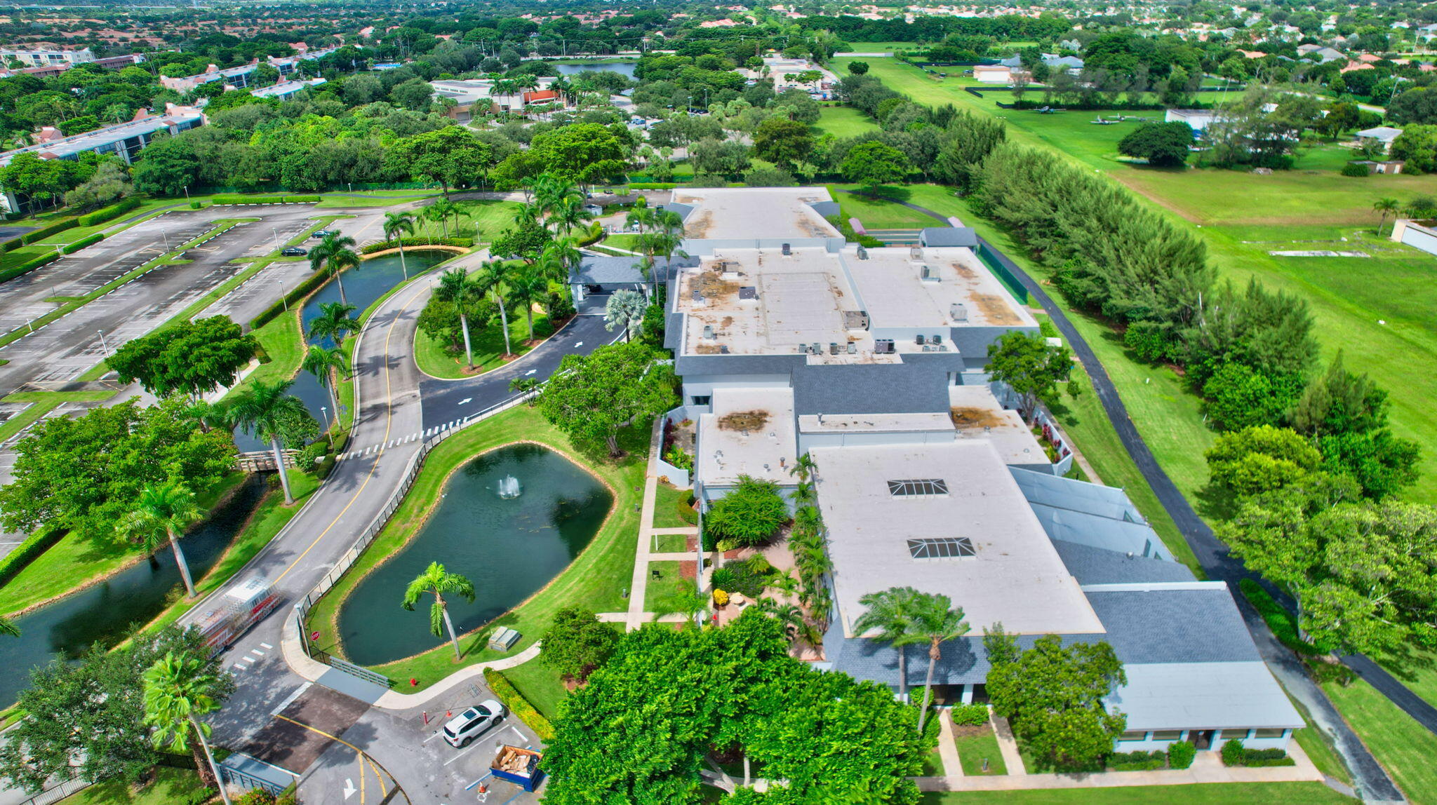 6935 Huntington Lane, Unit 207 Delray Beach, FL 33446 - Photo 69 of 88 an aerial view of a house with a yard and lake view