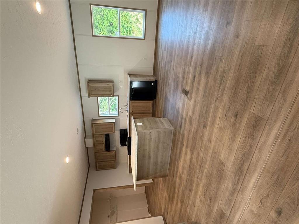 1052 Jones Ferry Road Elberton, GA 30635 - Photo 4 of 16 an empty room with wooden floor and windows