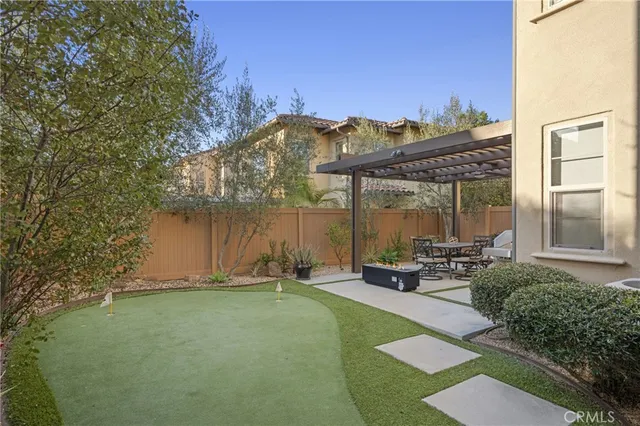 a backyard of a house with table and chairs