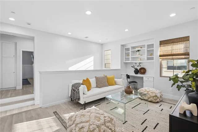 a living room with furniture and a potted plant