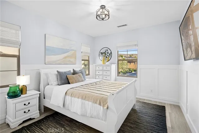 a bedroom with a white bed and a window