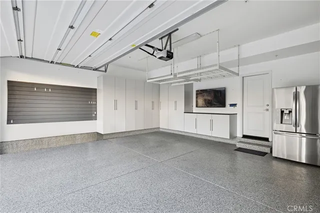 a view of a kitchen with a sink and a refrigerator