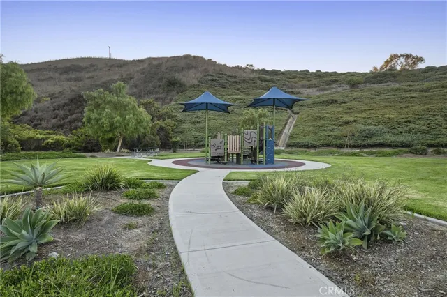 a view of a garden with mountains in the background