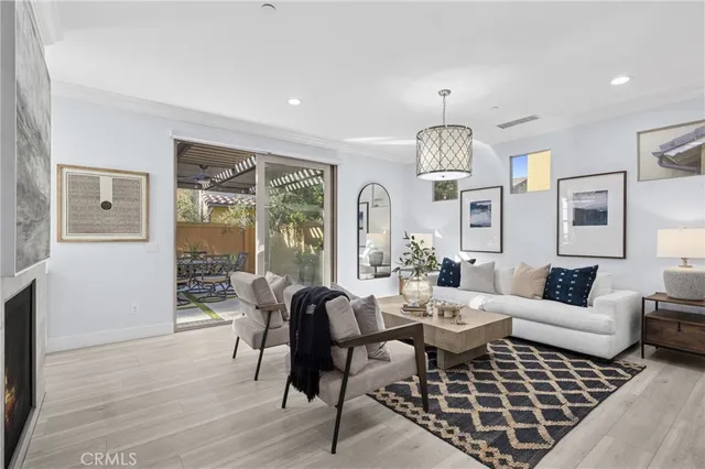 a living room with furniture a chandelier and a table