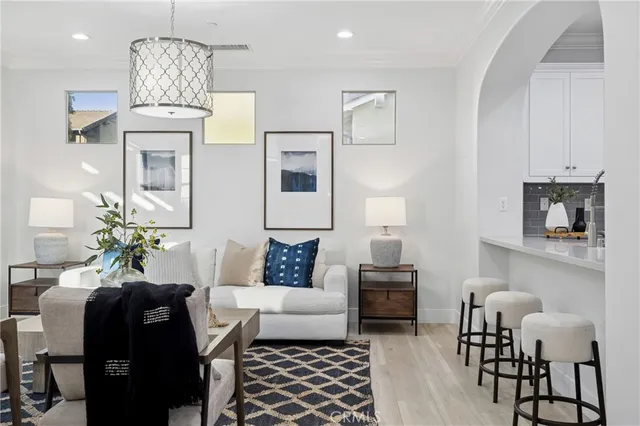 a living room with furniture and a chandelier