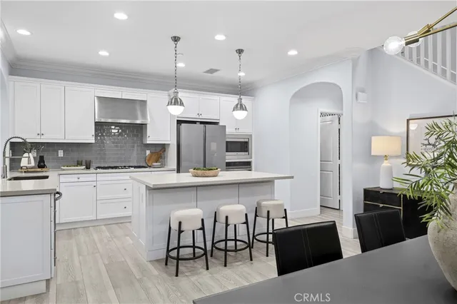 a kitchen with cabinets and wooden floor