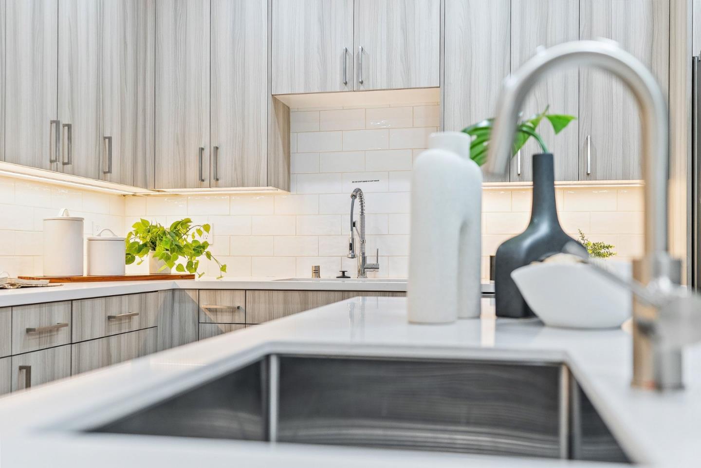 922 Woodside Road Redwood City, CA 94061 - Photo 17 of 30 a kitchen with a sink and a potted plant