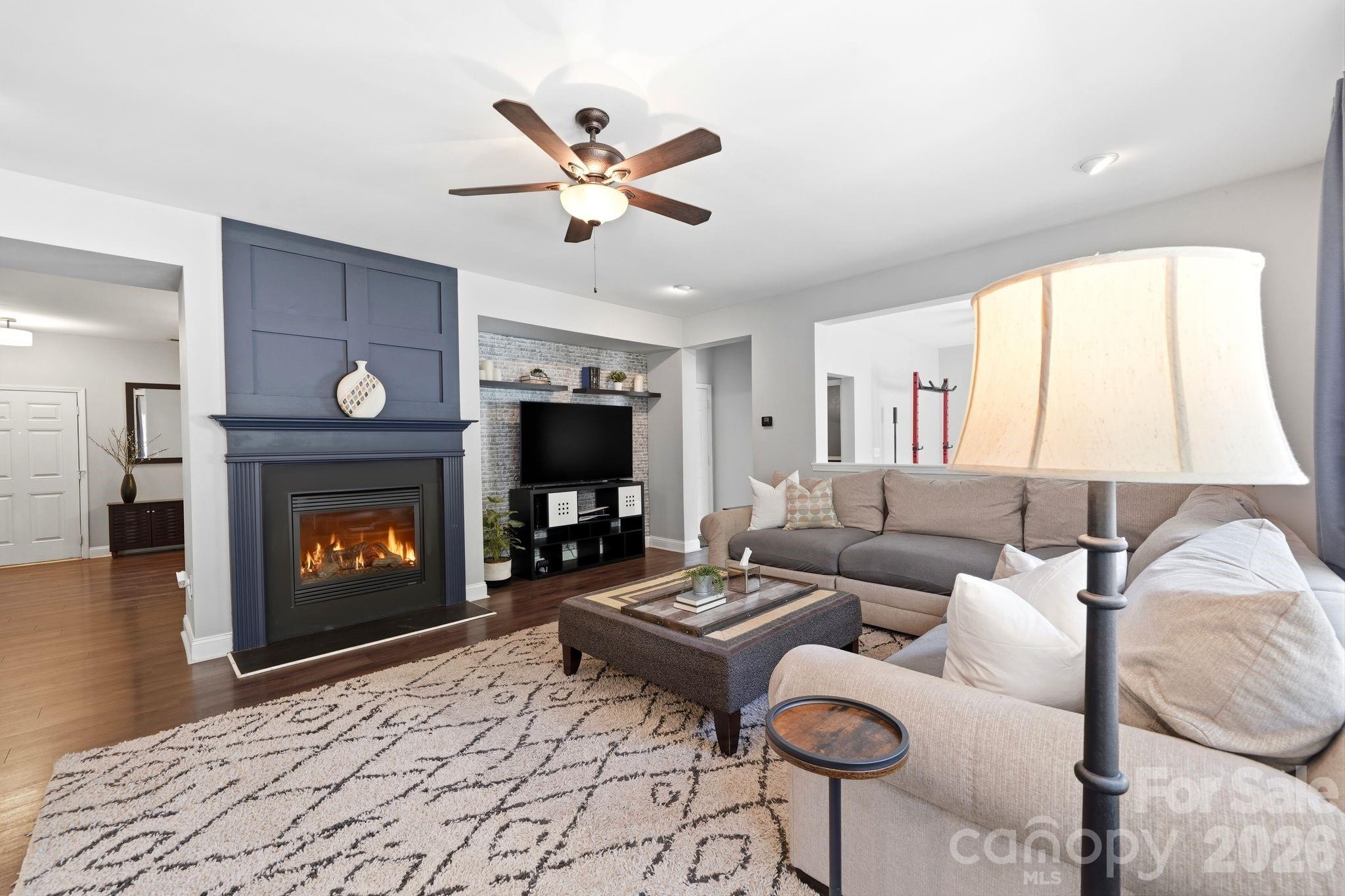 7815 Kuck Road Mint Hill, NC 28227 - Photo 11 of 29 a living room with furniture a fireplace and a flat screen tv
