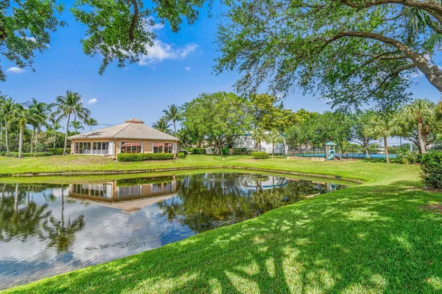 a view of swimming pool with a garden and plants