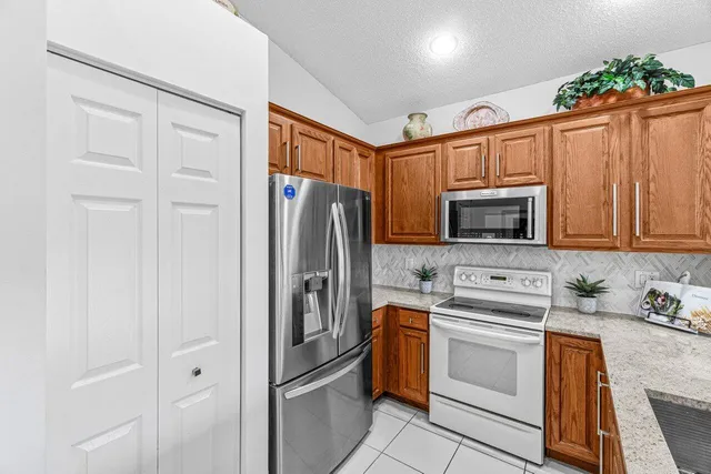 a kitchen with stainless steel appliances a refrigerator stove and sink