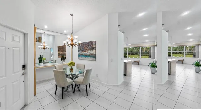 a dining room filled with furniture and a chandelier