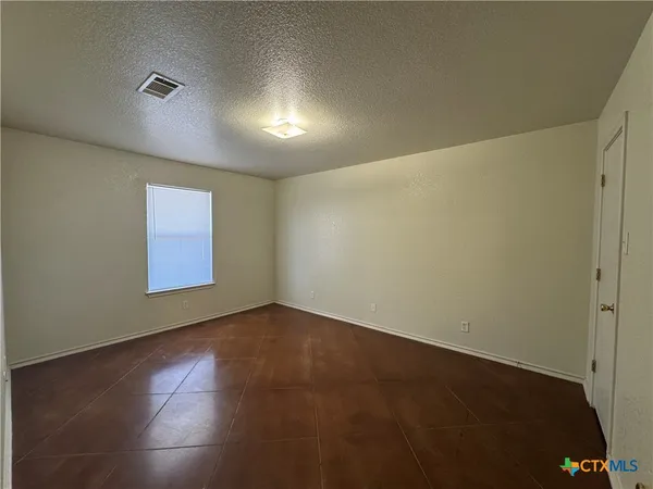 a bathroom with a granite countertop toilet sink and a mirror