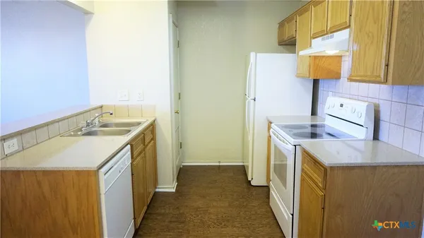 a utility room with a sink a washer and dryer