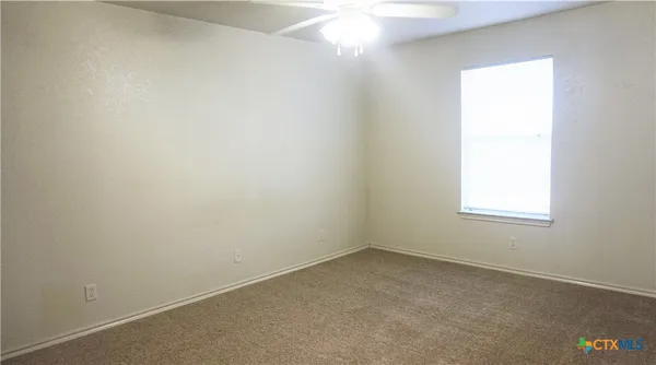 an empty room with closet and entryway
