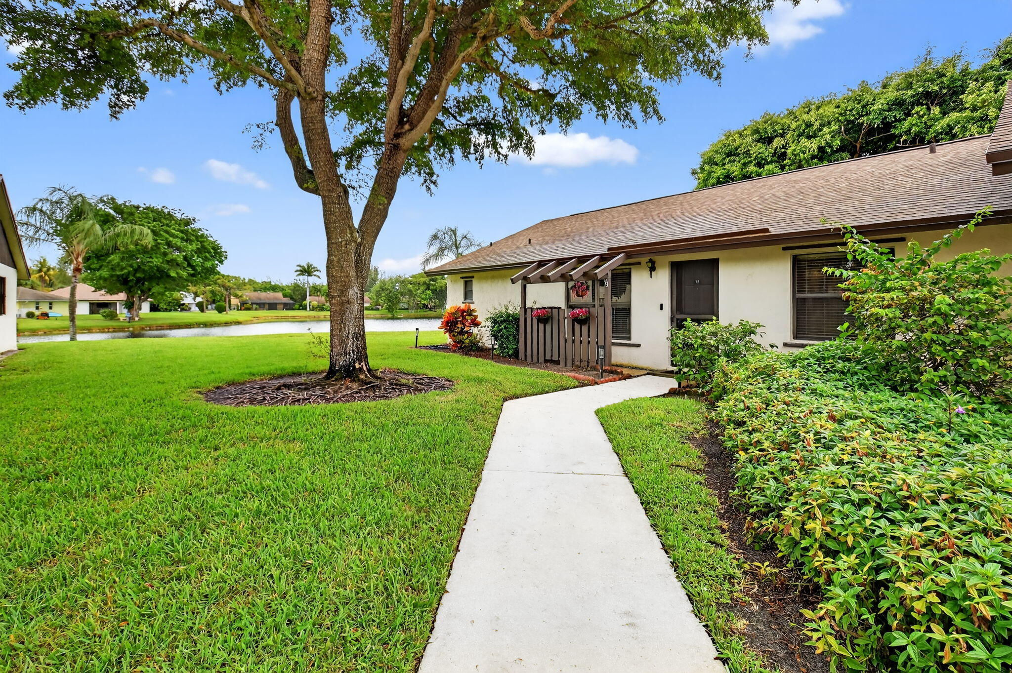 73 Vía De Casas Norte Boynton Beach, FL 33426 - Photo 1 of 60 a front view of a house with a yard