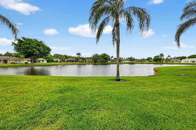 a view of a room with a ceiling fan and wooden floor