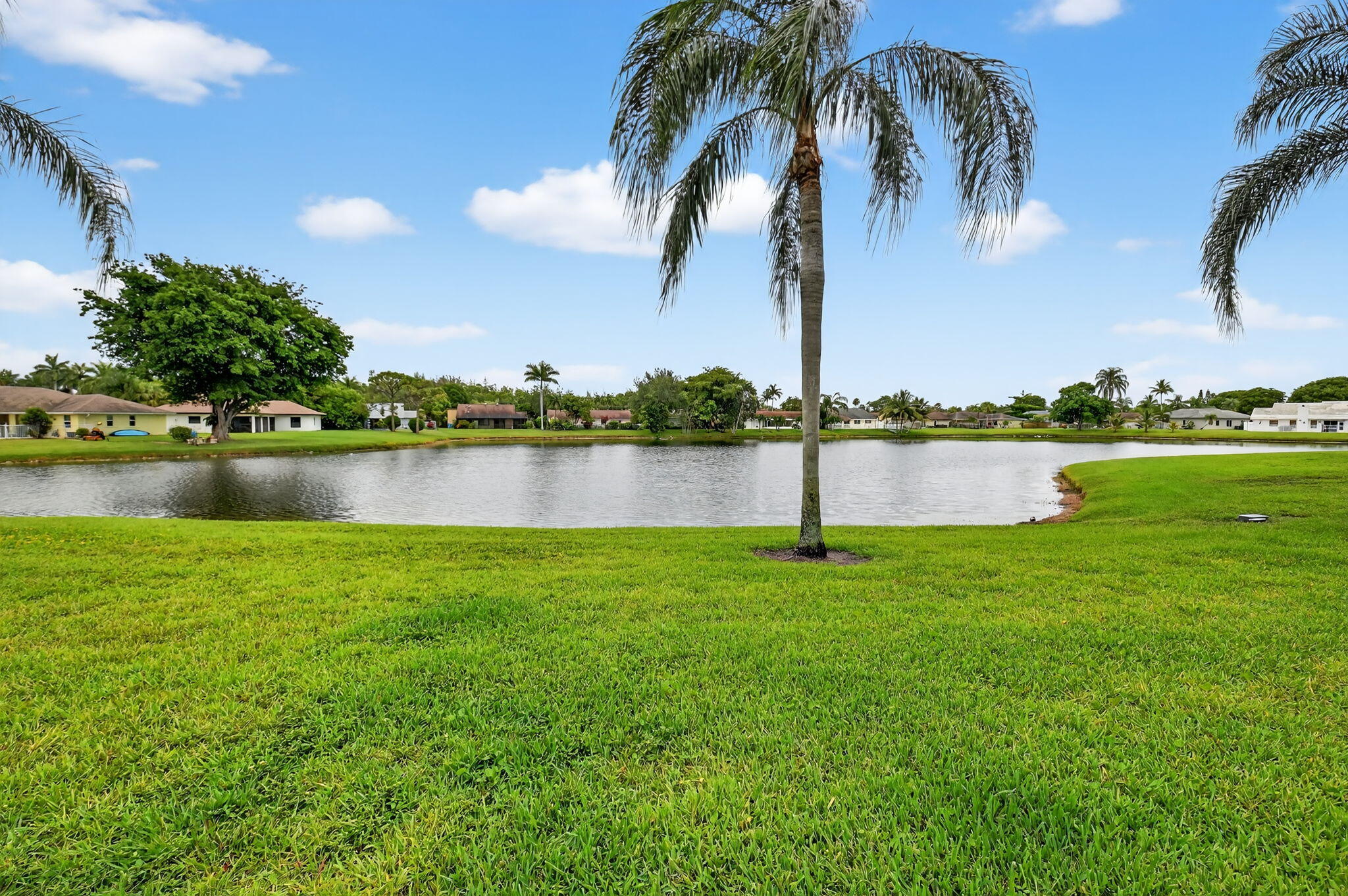 73 Vía De Casas Norte Boynton Beach, FL 33426 - Photo 12 of 60 a view of a lake with a big yard