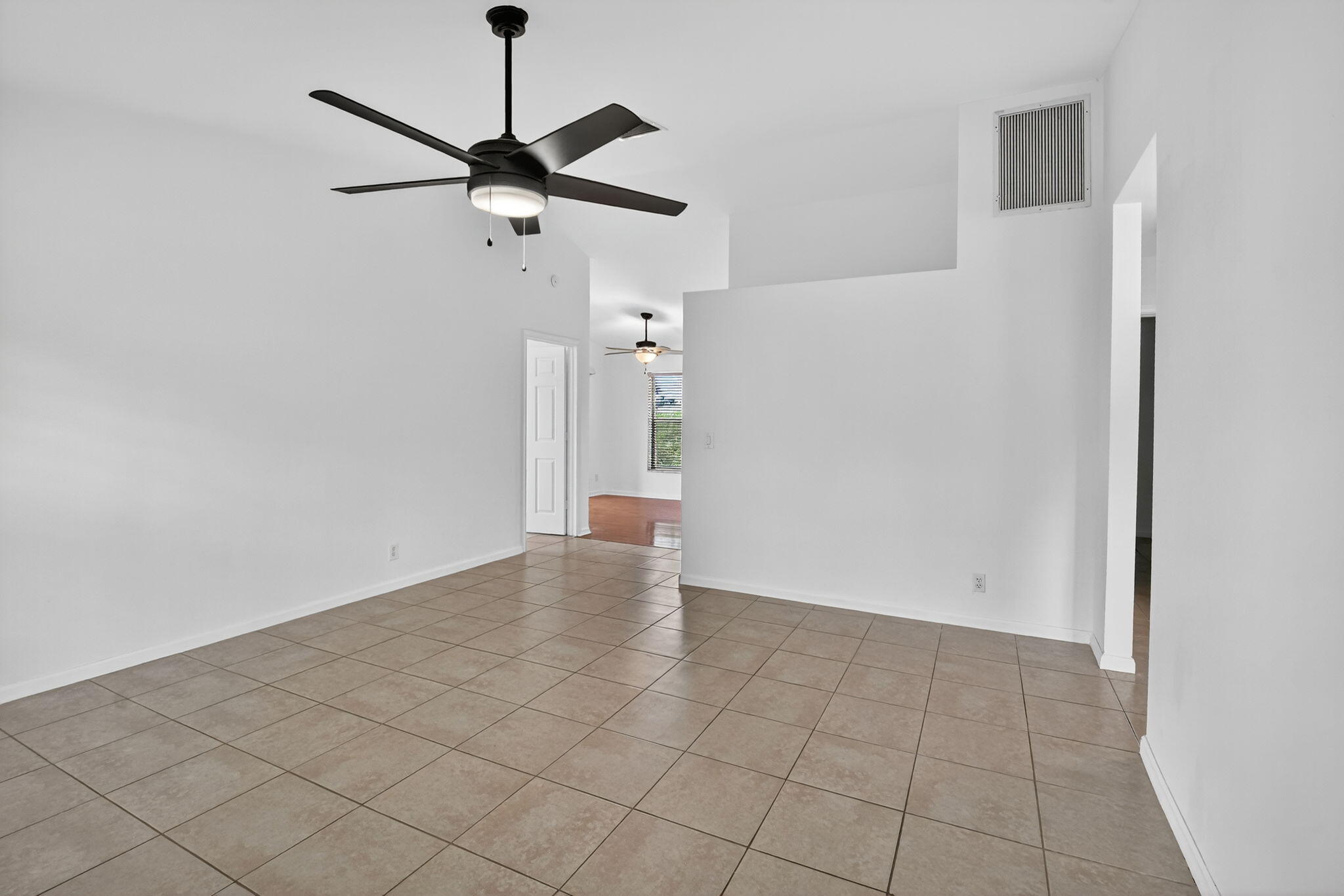 73 Vía De Casas Norte Boynton Beach, FL 33426 - Photo 14 of 60 a view of a room with a ceiling fan and wooden floor