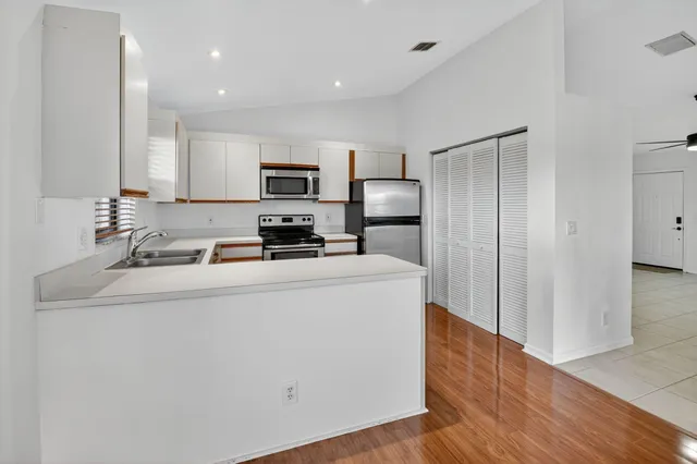a view of a kitchen with a sink and a window