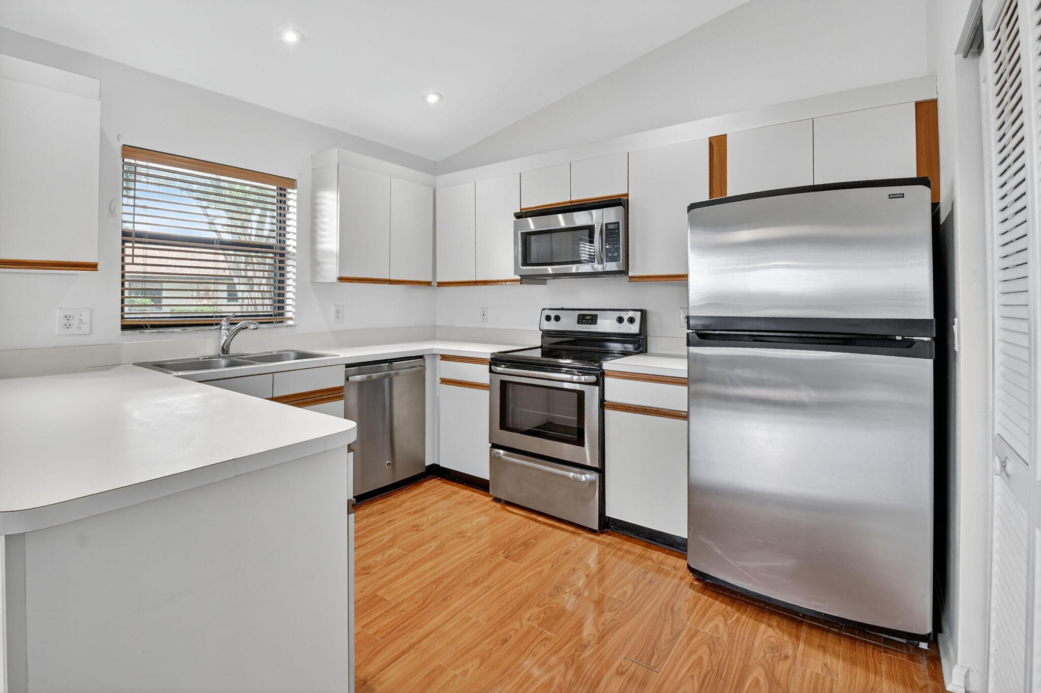 73 Vía De Casas Norte Boynton Beach, FL 33426 - Photo 19 of 60 a kitchen with a refrigerator sink and cabinets
