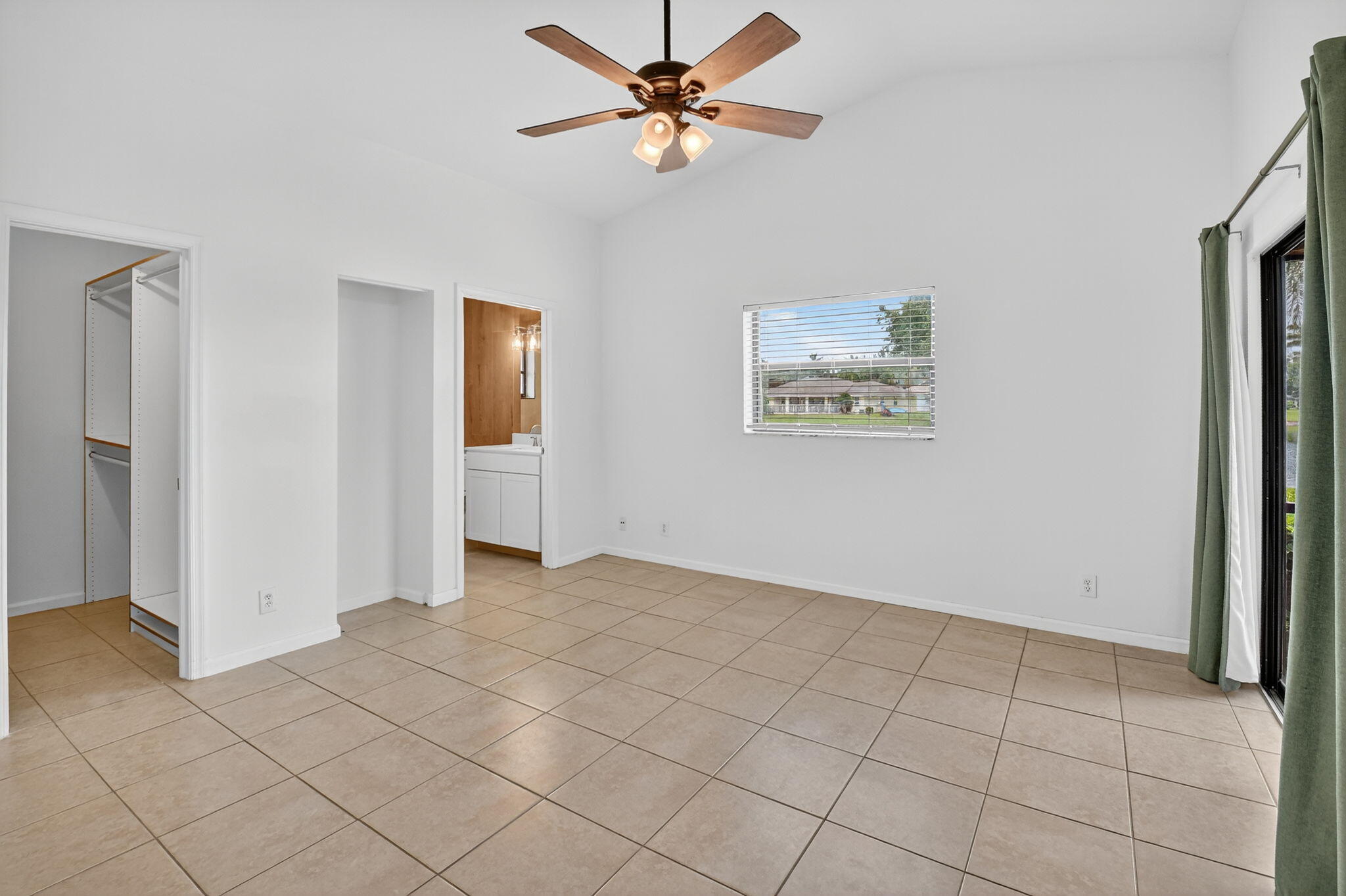 73 Vía De Casas Norte Boynton Beach, FL 33426 - Photo 22 of 60 an empty room with windows and fan