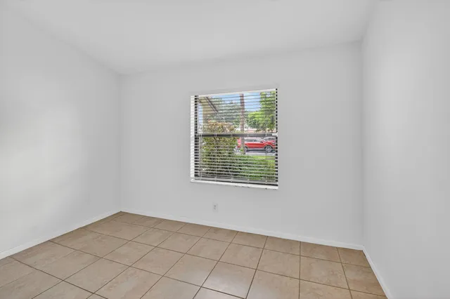 a bathroom with a granite countertop sink a toilet a mirror and shower