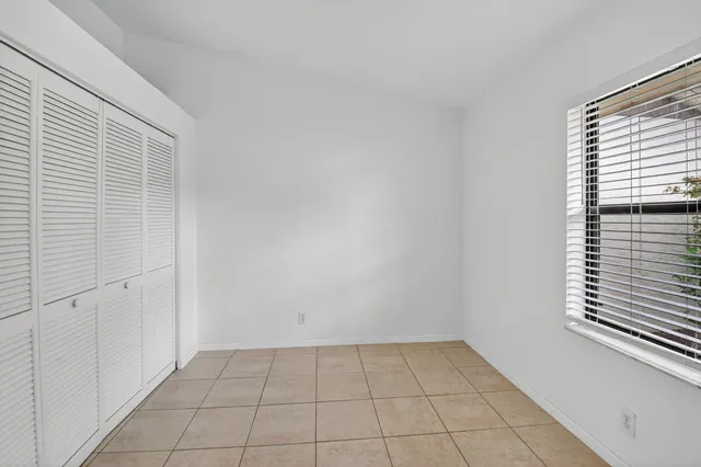 a bathroom with a granite countertop toilet sink and mirror