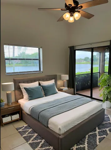 a bedroom with a bed and a large window