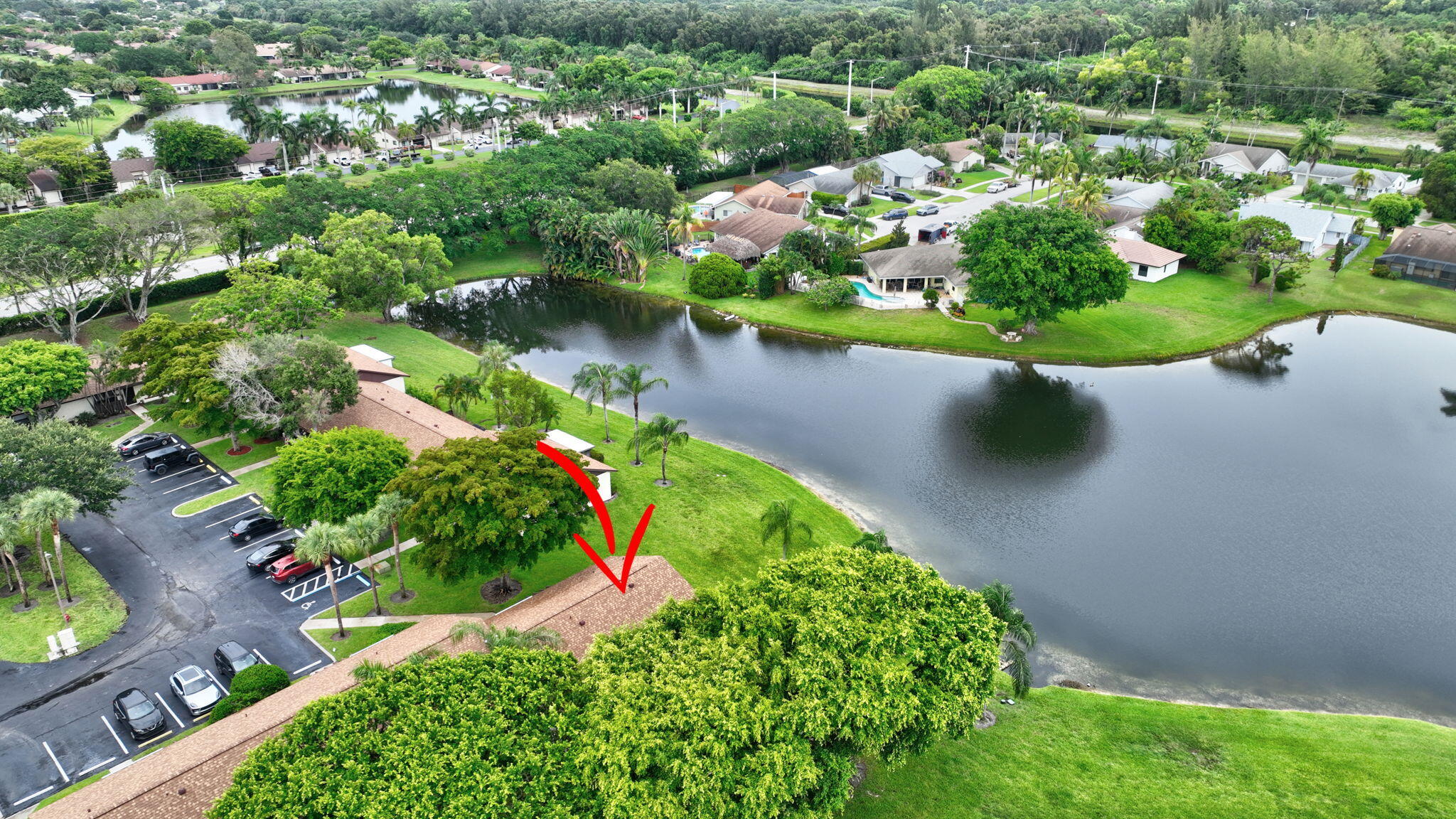 73 Vía De Casas Norte Boynton Beach, FL 33426 - Photo 45 of 60 an aerial view of a house with a yard and lake view