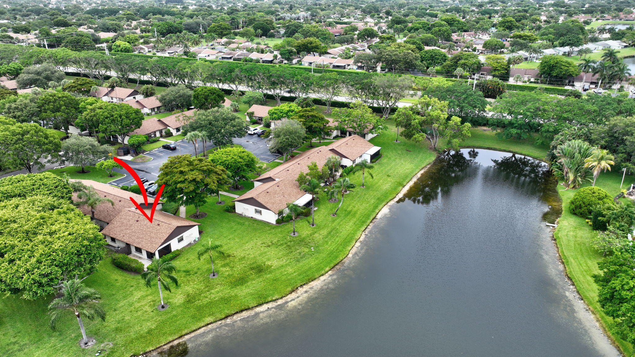 73 Vía De Casas Norte Boynton Beach, FL 33426 - Photo 47 of 60 an aerial view of a house with a garden and lake view