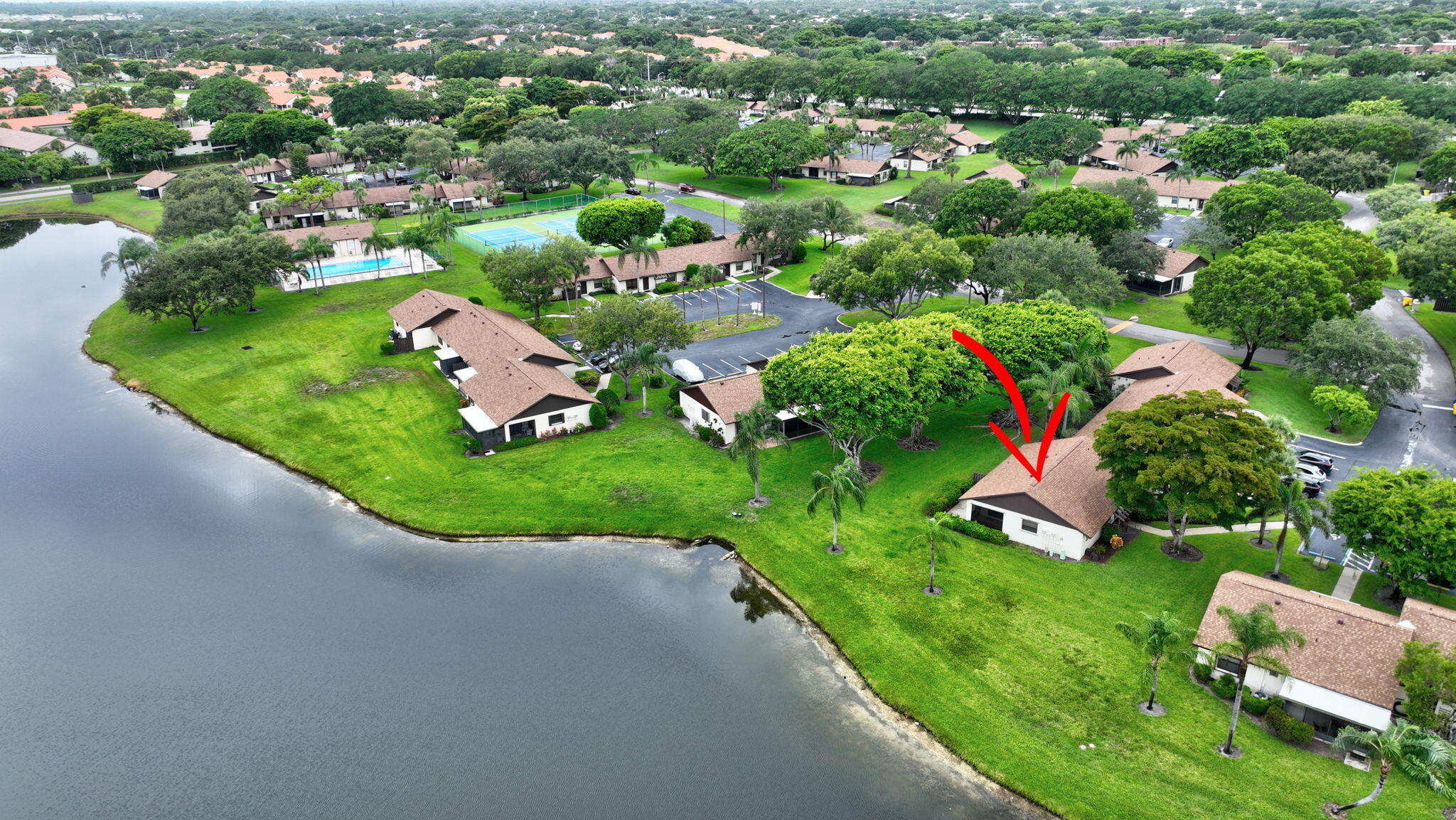 73 Vía De Casas Norte Boynton Beach, FL 33426 - Photo 49 of 60 a view of a garden with a building in the background
